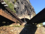 Mile 60.7: Trains often pass through the B&O Railroad tunnel and across the bridges at Harpers Ferry, which is on the opposite side of the Potomac from the canal. To reach town, you climb a wide spiral staircase here and take the walkway on one of the bridges.