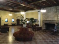 A massive fireplace anchors the lobby. Lavish paintings of Florida scenes and European motifs cover the ceiling beams.